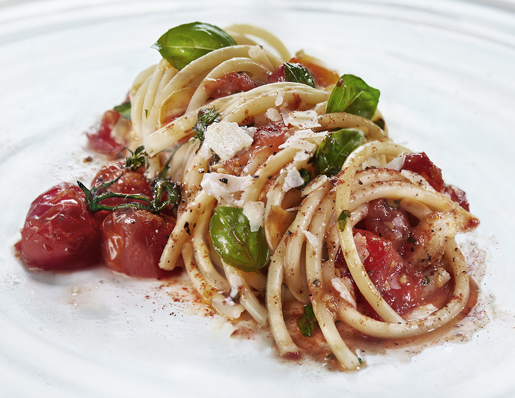 Classic roasted cherry tomato and basil sauce tossed with bucatini, finished with shaved parmesan