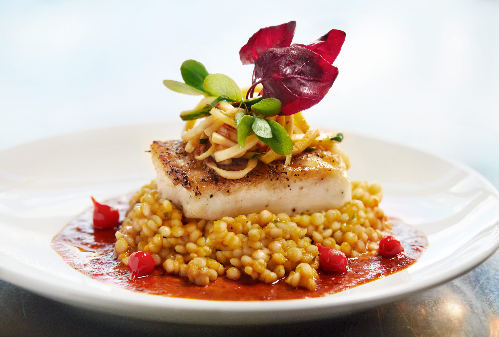 Wild Alaskan Halibut with toasted butternut squash and Israeli couscous in achiote pineapple broth