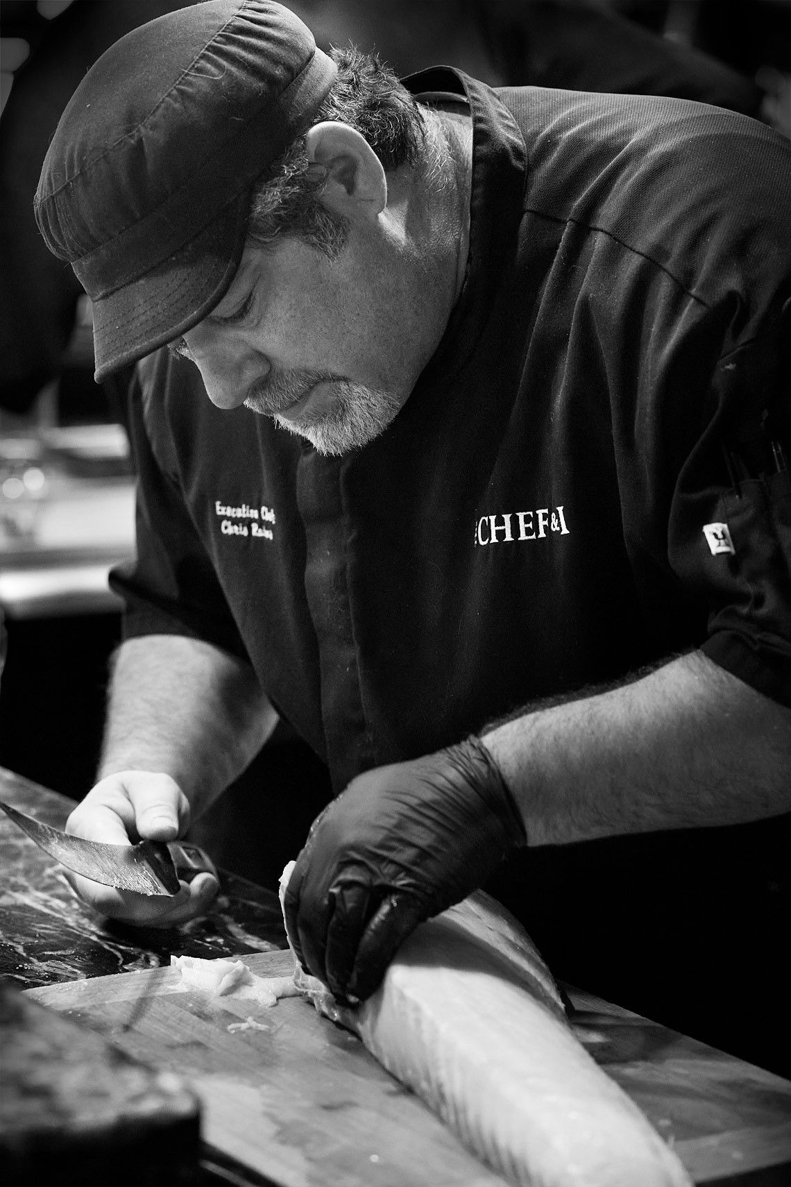 Chef Chris Rains filleting whole fish