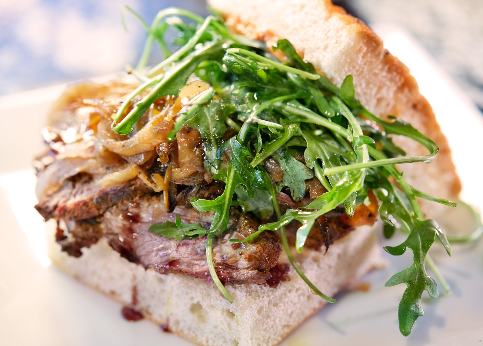Roast Beef Sandwich with balsamic onions and arugula on garlic focaccia.
