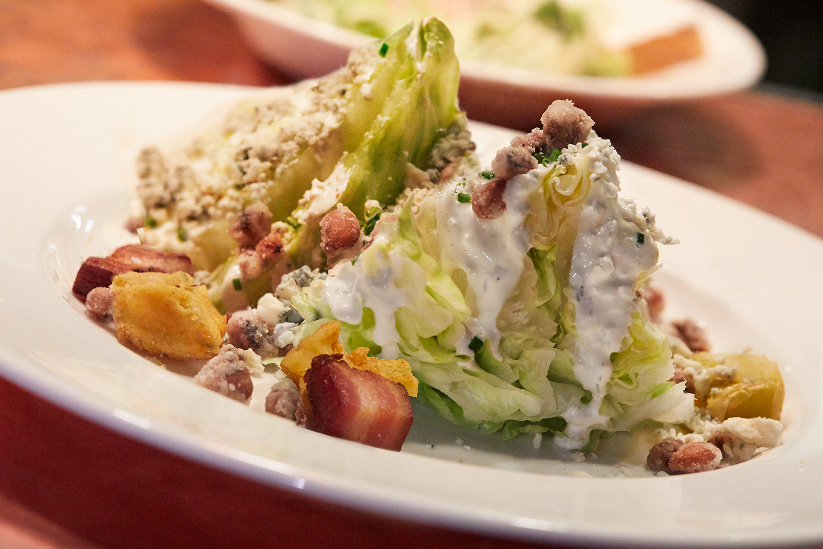 Southern Wedge Salad with fried green tomatoes, crispy fried black eyed peas, bacon lardons and bleu cheese dressing. The Southern Steak and Oyster Restaurant in Nashville