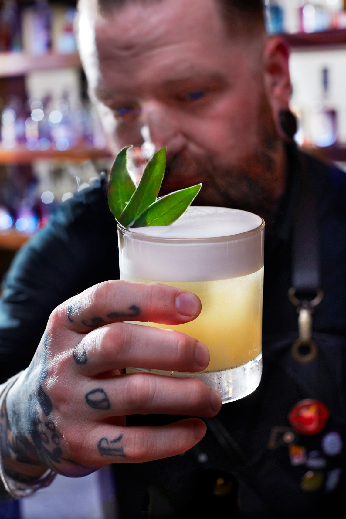 Sinema Restaurant Whiskey Sour cocktail with hand Tattoo
